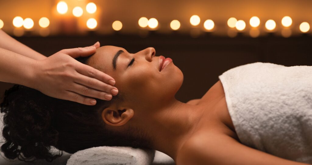 Spa guest receiving a head massage