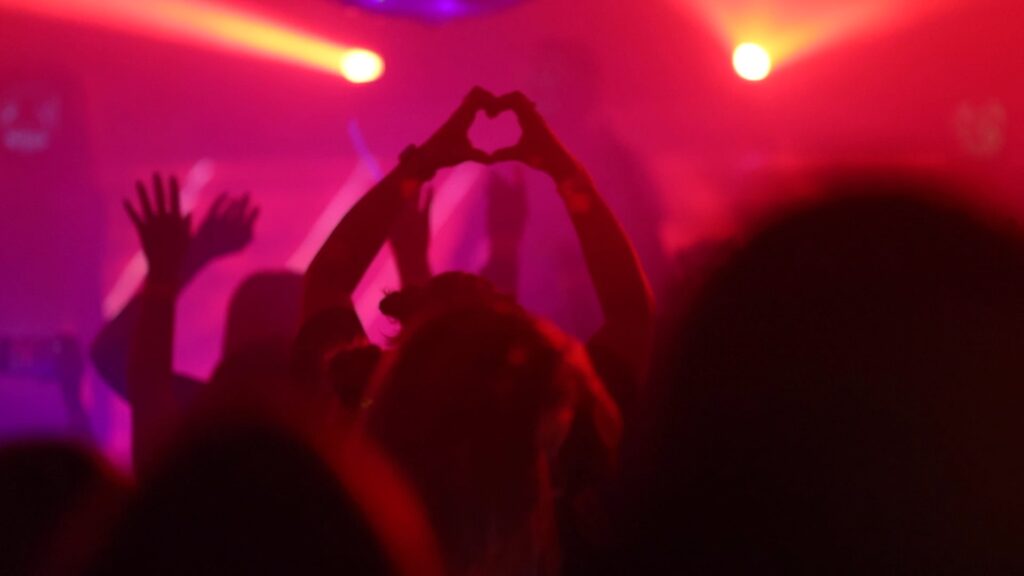 Tribute night audience making a heart with hands