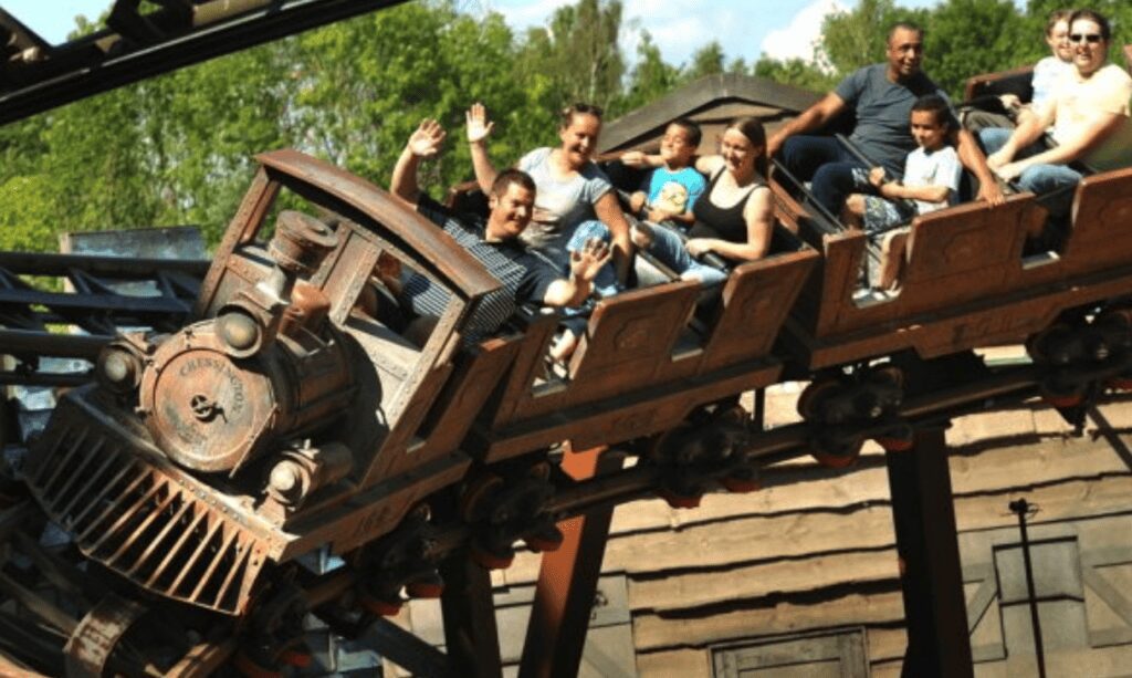 Excited group enjoying a roller coaster ride at Old Thorns Adventure Park.
