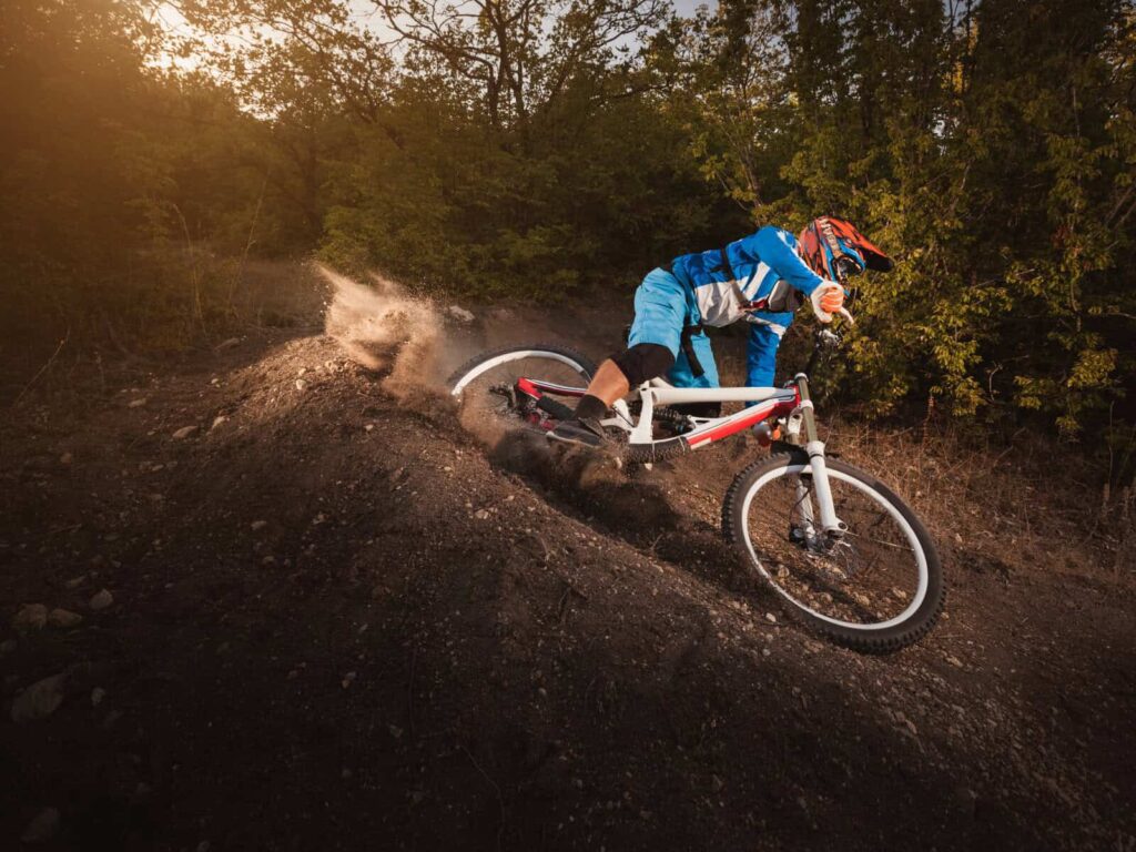 Mountain biker riding downhill on a dirt trail at Old Thorns golf and leisure resort.