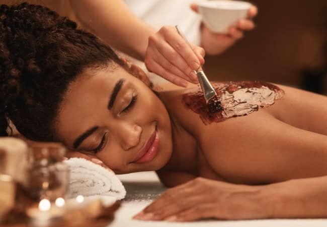 Relaxing body wrap with herbal scrubs for skin rejuvenation and stress relief.