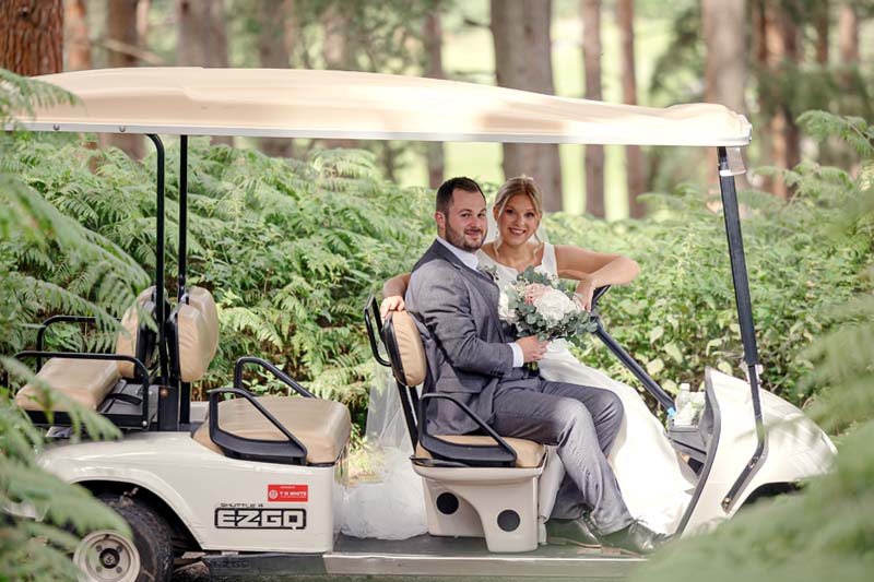Wedding couple on Golf Buggy on the Old Thorns Golf Course
