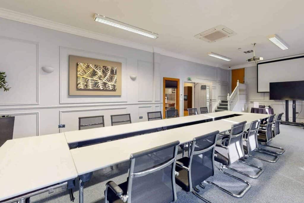 Conference room with large table and chairs at Old Thorns Golf & Spa Resort.