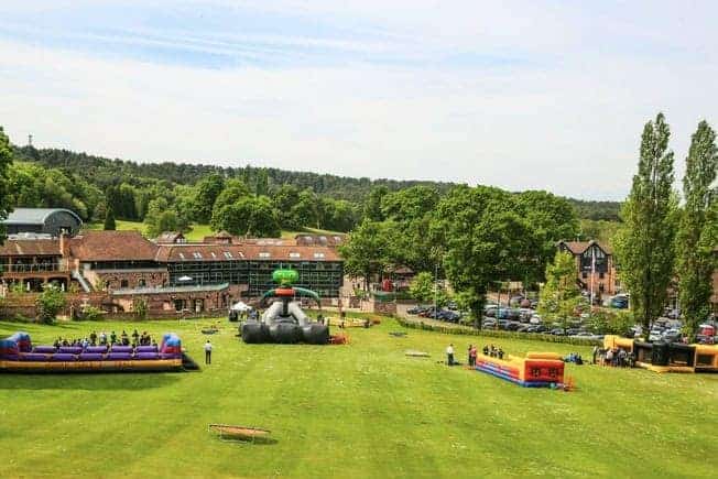 Scenic view of Old Thorns golf course with fun rides and lush greenery.