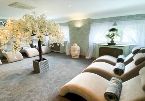 Relaxation lounge in the spa with comfortable loungers and throws